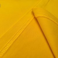 Chi tiết vạt áo áo thun cổ tròn ngắn tay cotton cao cấp màu vàng đậm