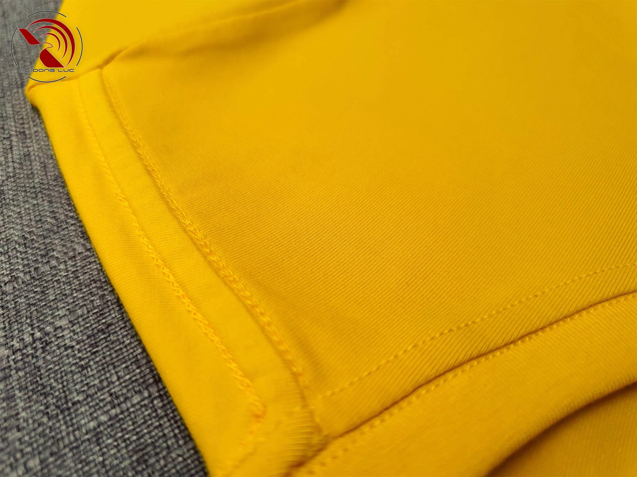 Chi tiết đường may móc xích vai áo thun cổ tròn cotton cao cấp màu vàng đậm