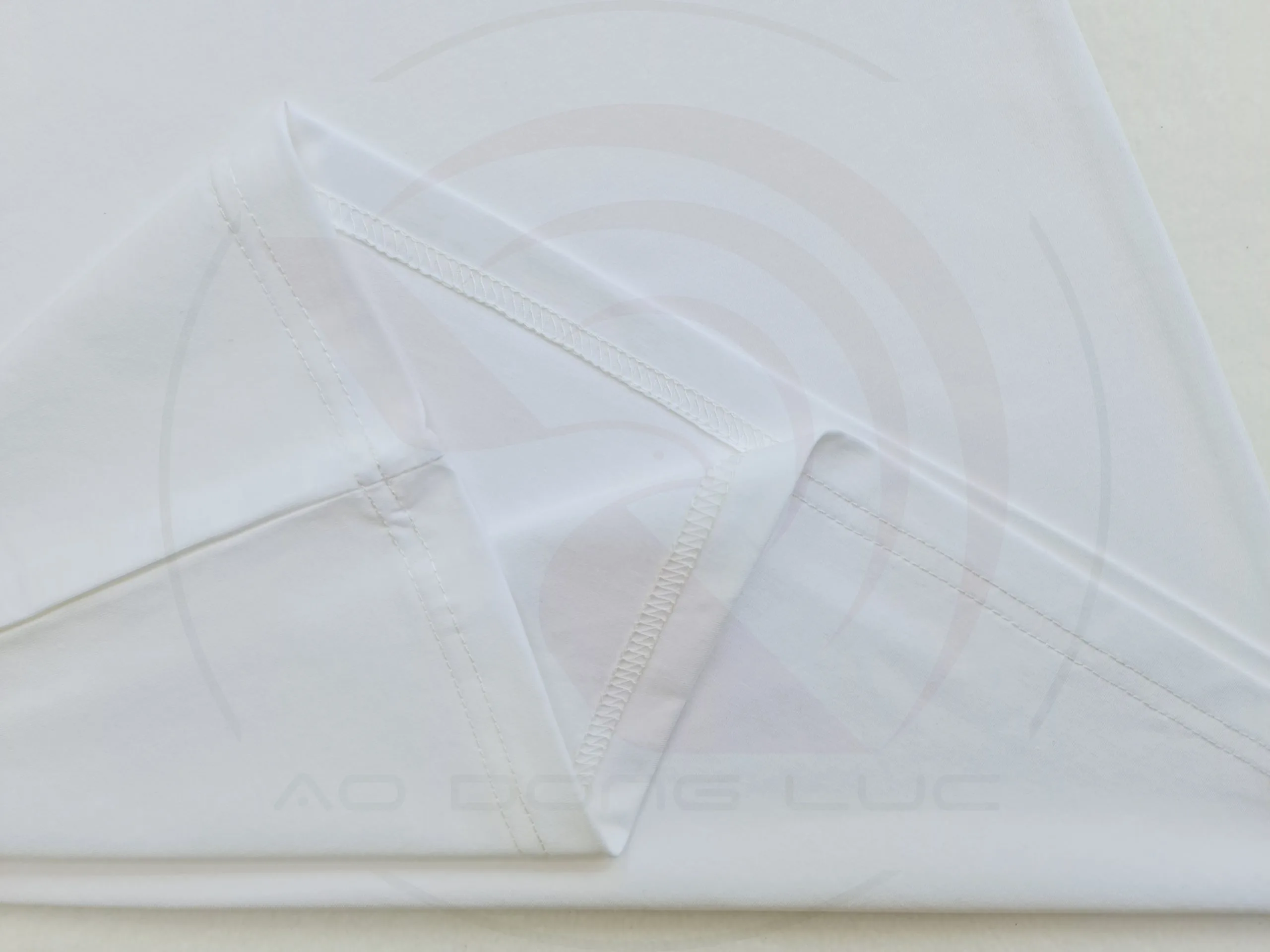 Chi tiết đường may và vạt áo áo thun cổ tròn ngắn tay cotton unisex màu trắng